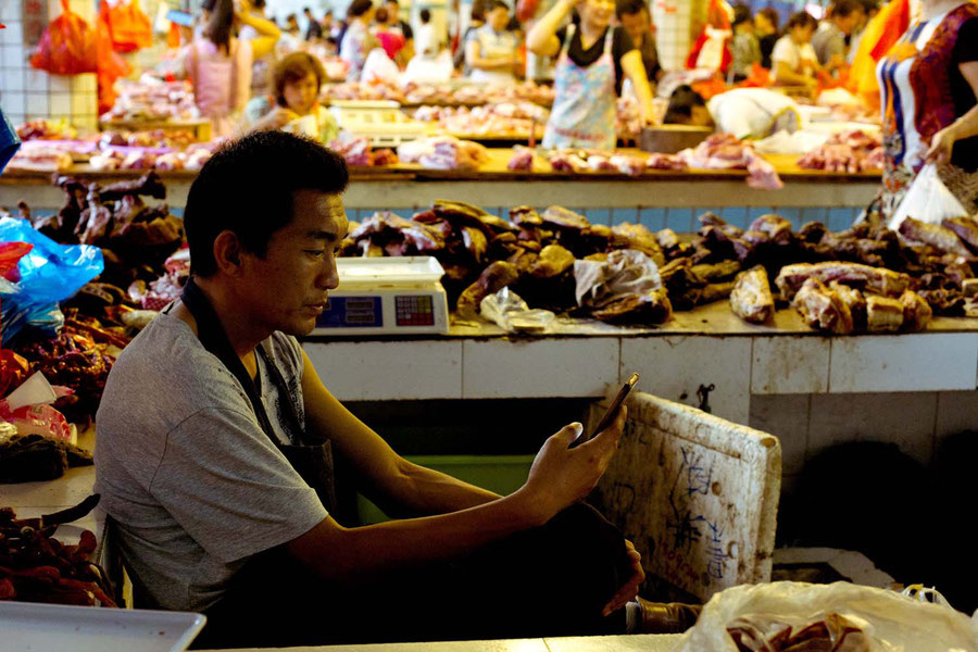 The boy behind the meat counter, Jinghong, China