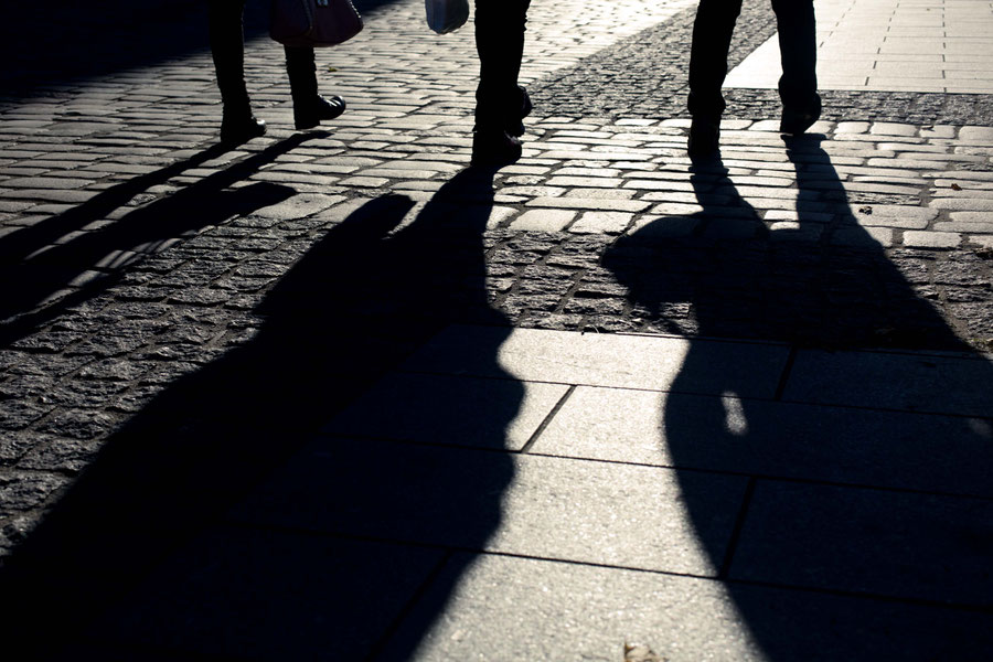 Long shadows of passersby in Tallinn, Estonia.