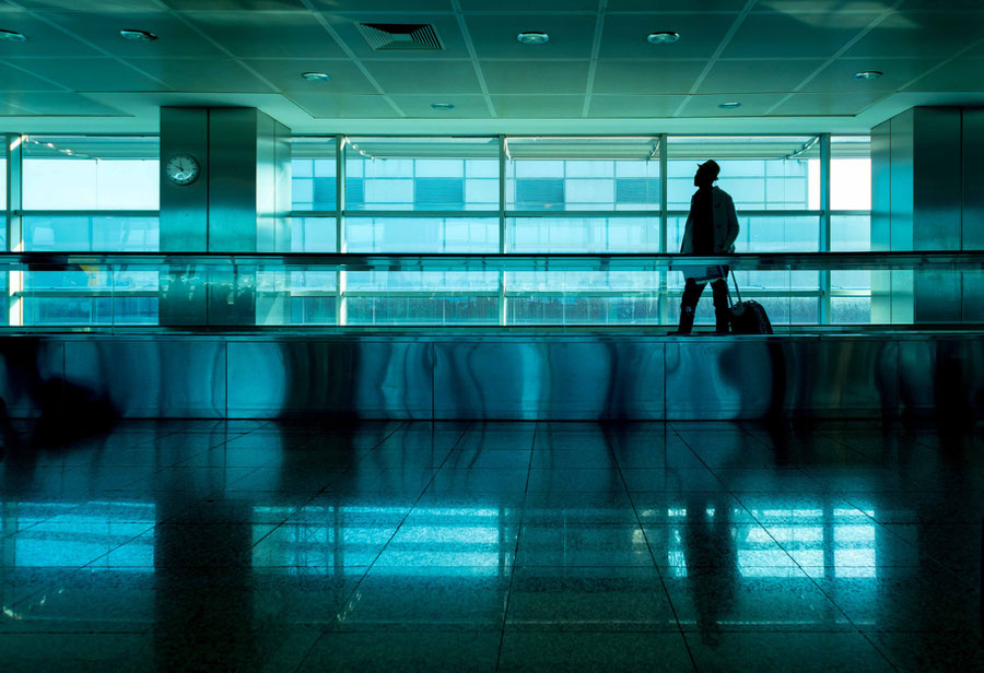 A traveller is captured on the walking band in an airport