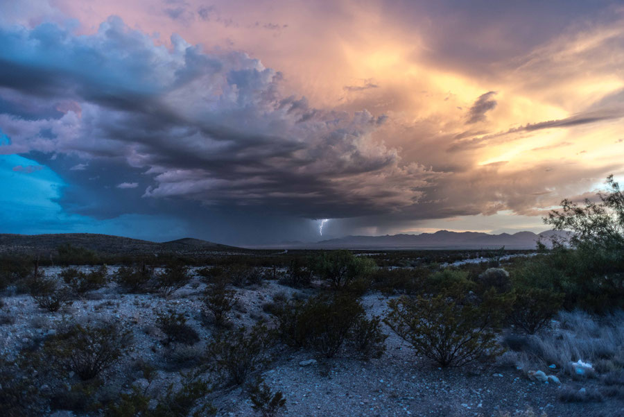 Electric skies of New Mexico with a lightning and clouds in the horizon.