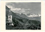 Kirche St. Magdalena in Prazöll , ehem. Landgemeinde Zwölfmalgreien (seit 1911 Katastralgemeinde von Bozen) mit Rosengartengruppe von Westen. Gelatinesilberabzug 10 x 15 cm; Impr.: Joh. F. Amonn, Bozen/Aufn. F. Plunger 1931.  Inv.-Nr. vu105gs00010