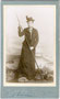 Dame in Alpinkleidung und mit Bergstock vor bemalter Hintergrundkulisse im Atelier. Albuminabzug auf silbergeprägtem Untersatzkarton 6,5 x 10 cm (Visitformat). Impressum: Jos(ef). STIEGLER, Stumm im Zillerthal um 1895.  Inv.-Nr. vuVIS-00072