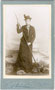Dame in Alpinkleidung und mit Bergstock im Atelier. Albuminabzug auf silbergeprägtem Untersatzkarton 10,5 x 6,5 cm (Visit-Format). Impressum: Jos(ef). Stiegler, Stumm im Zillerthal um 1895.  Inv.-Nr. vuVIS-00072