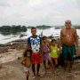 Brazilian indigenous family of the Araras tribe in front of Xingu river