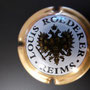 Marque : ROEDERER Louis N° Lambert : 95a - type 6 Couleur : Contour Or, verso Or Description : Blason aigle à 2 têtes, tenant   dans ses serres 1 sceptre et un globe,   écusson central contenant un chevalier en   armure.  Emplacement : 094-06-02  