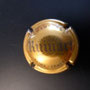 Marque : RUINART N° Lambert : 49 Couleur : Or et Gris  - 32mm   Description : Nom de la marque sur un blason couronné  Emplacement : 096-06-05