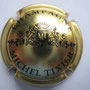 Marque :  TIXIER Michel N° Lambert : 8 Couleur : Or et Noir Description : Lettres MT dans un blason couronné soutenu par deux lions  Emplacement : 102-04-03
