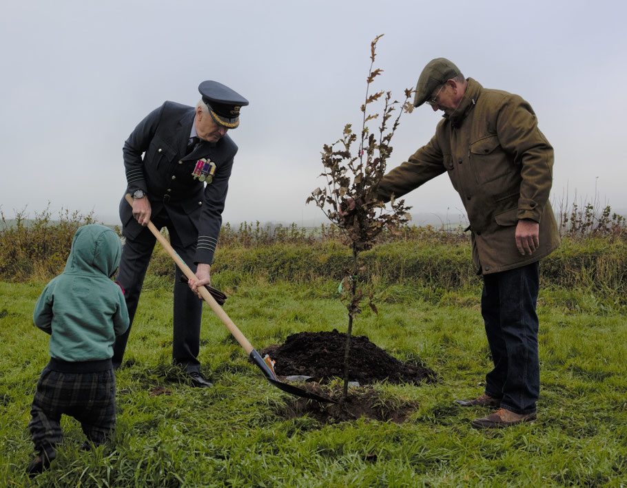 Group Captain Mike Trace planting the tree