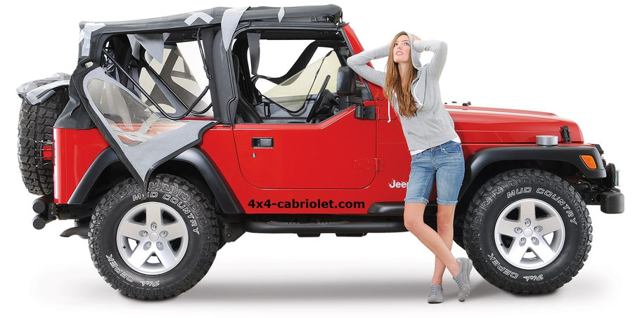 Capote Jeep Wrangler TJ nera completamente strappata, da sostituire con una nuova. Jeep Wrangler TJ di colore rosso.