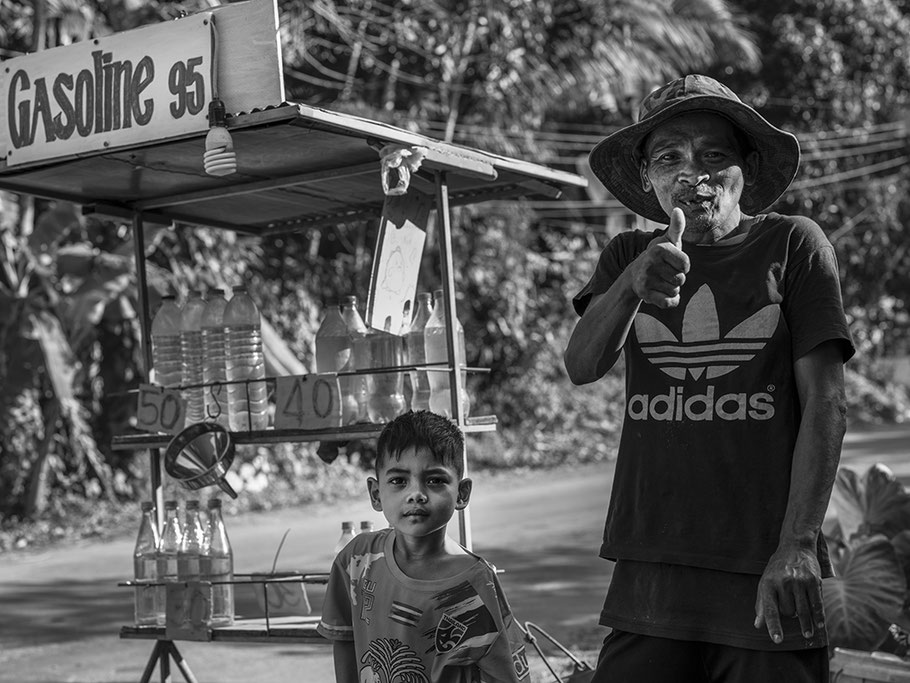 Verkauf von Benzin in herkömmlichen Getränkeflaschen am Straßenrand in Thailand als SW-Fotografie