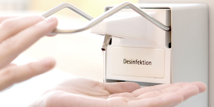 Desinfektionsspender mit Hand