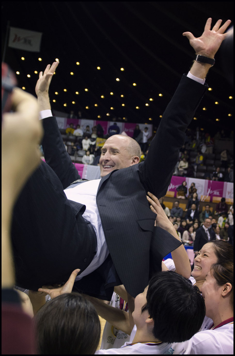 Sunflowers head coach Tom Hovasse gets the bumps after his team's championship. — Chris Pfaff, Inside Sport: Japan, March 12, 2017