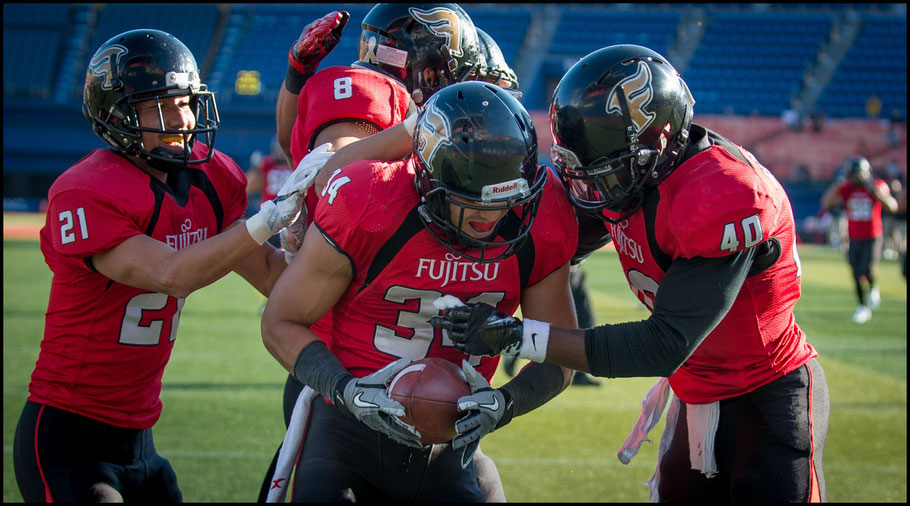 Adeyemi (right) celebrates a pick-six in the playoffs — John Gunning, Inside Sport: Japan, Nov 12, 2016