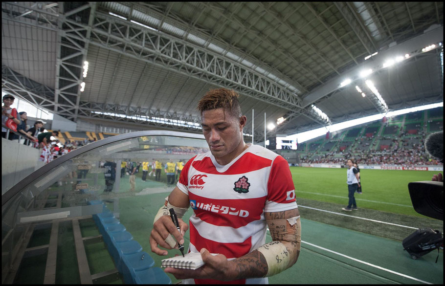 Amanaki Mafi signs autographs with the closed roof visible behind him - Lionel Piguet, Inside Sport: Japan, June 16th, 2018