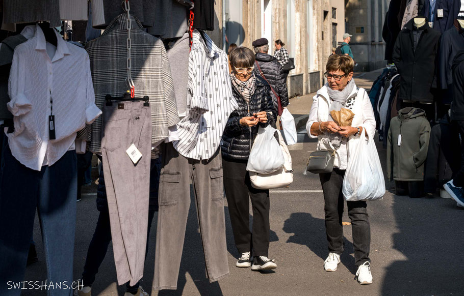 Stand am Markt von Luino mit zwei Frauen mit Einkaufstüten und Maroni