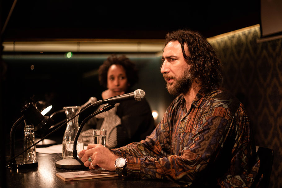 Lubi Barre interviewing author Ghayath Almadhoun before the reading