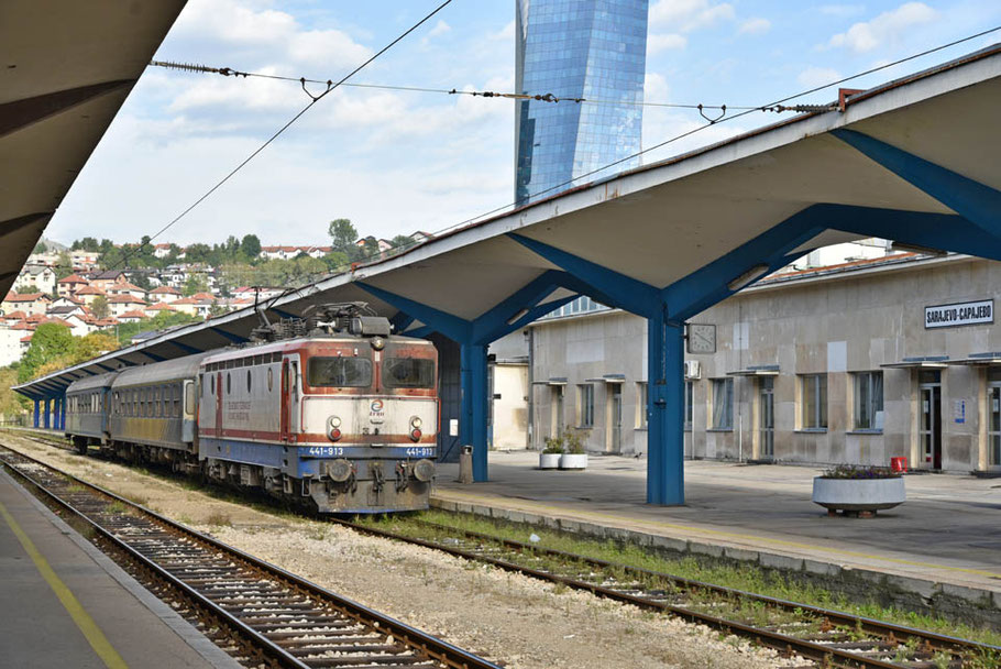 Bahnhof Sarajevo Bahnsteig 1, ŽFBH 441-913 vor Lokalni 2156 am 08.10.2023 und Avaz Twist Tower im Hintergrund
