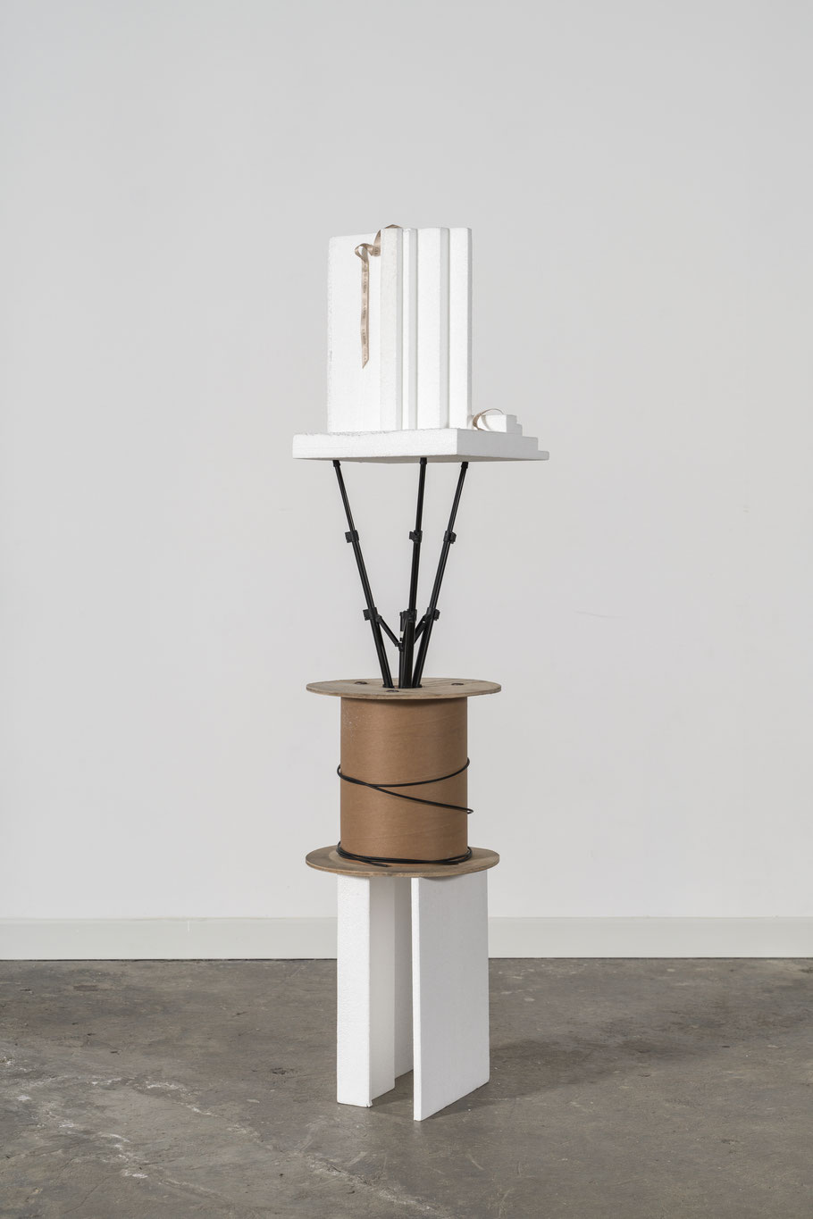 Birthday Present, 2024 ca. 165 x 40 x 40 cm Moulded polystrene parts, wooden cable reel, tripod, ribbon