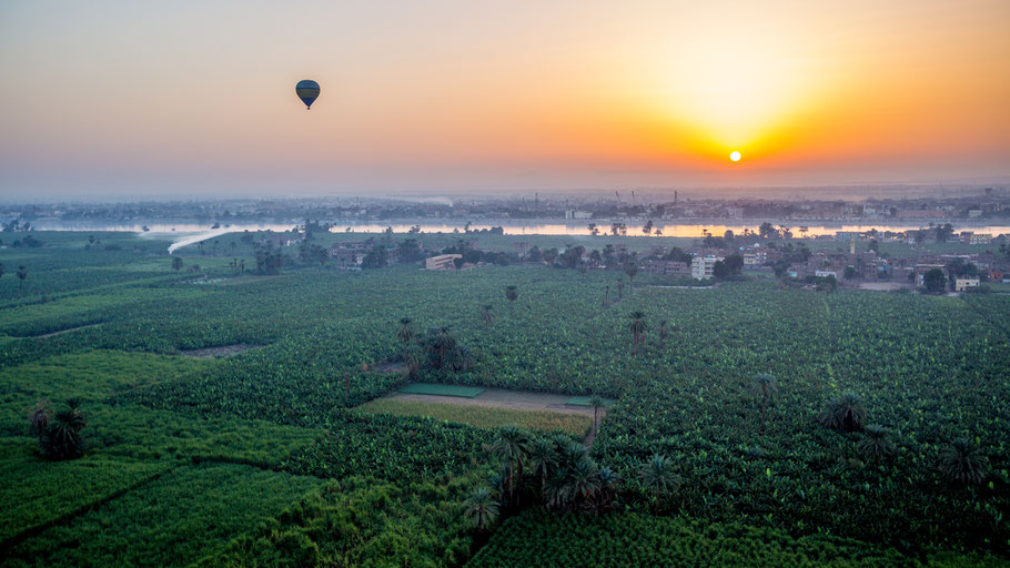 Sunrise from a balloon over Thebes and Nile river