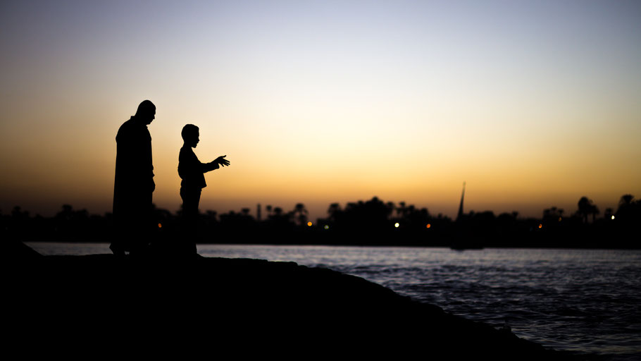 Father and son silhouette at Nile river, Luxor