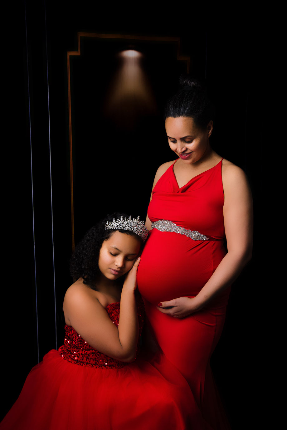 pregnant woman with daughter with crown