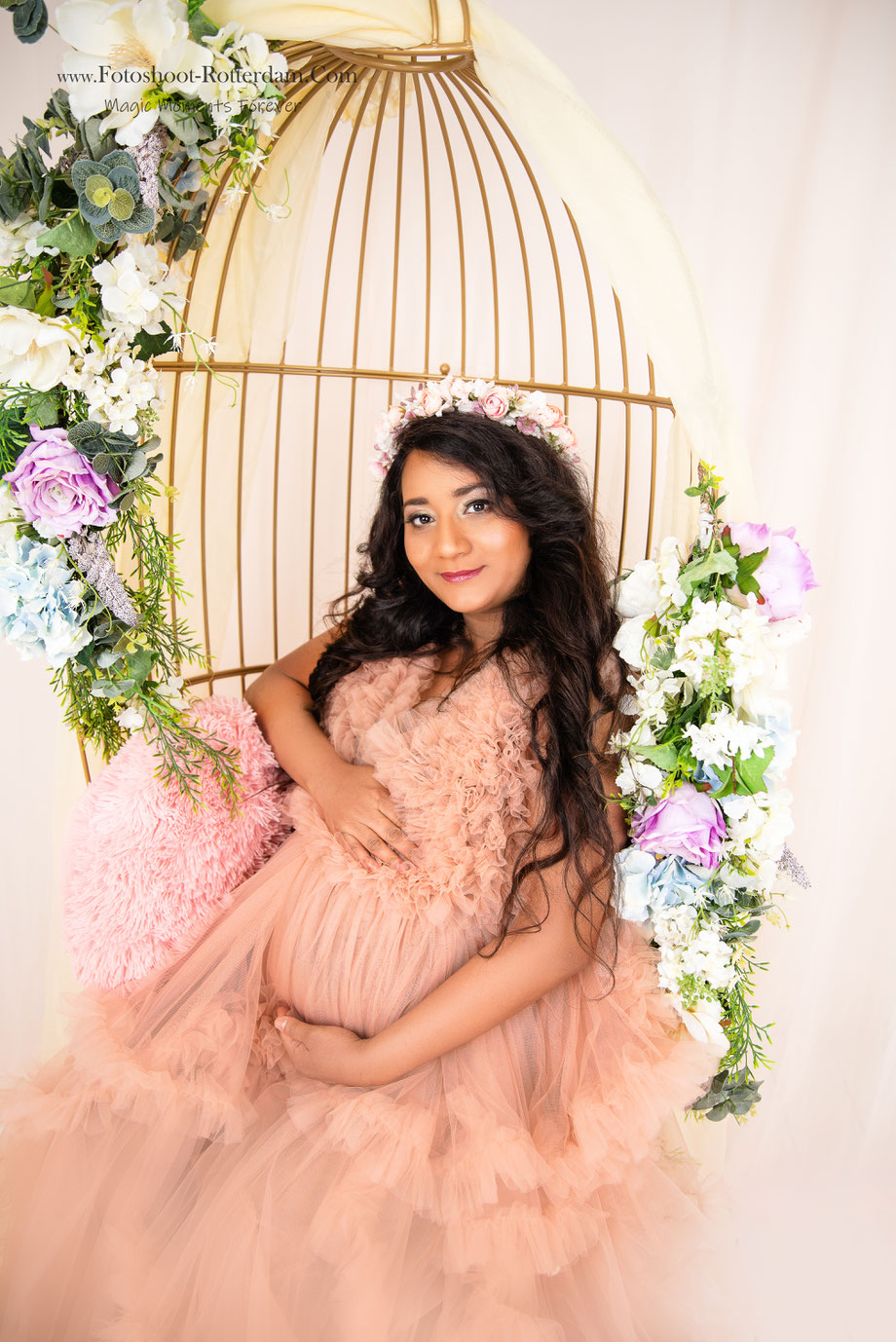 pregnancy shoot with flowers and golden cage