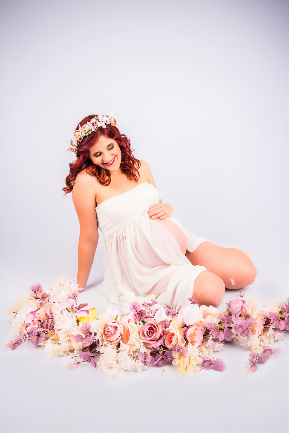 maternity shoot with flowers on floor