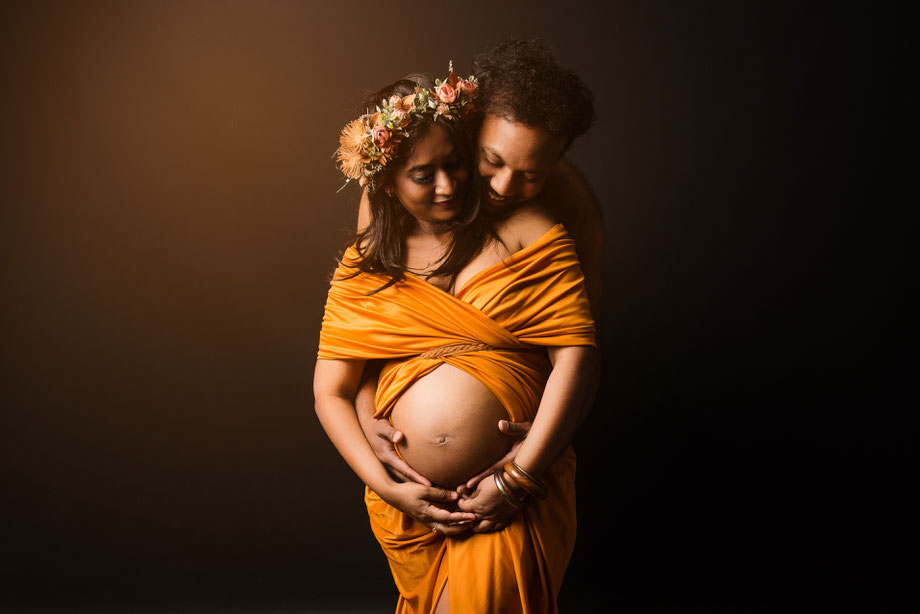 pregnant woman with husband behind her