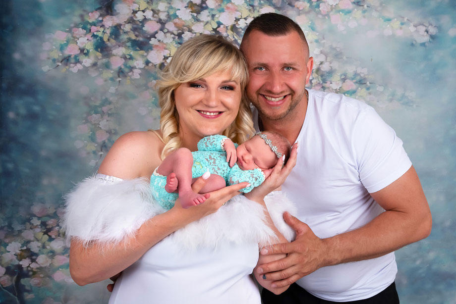 laughing parents with newborn