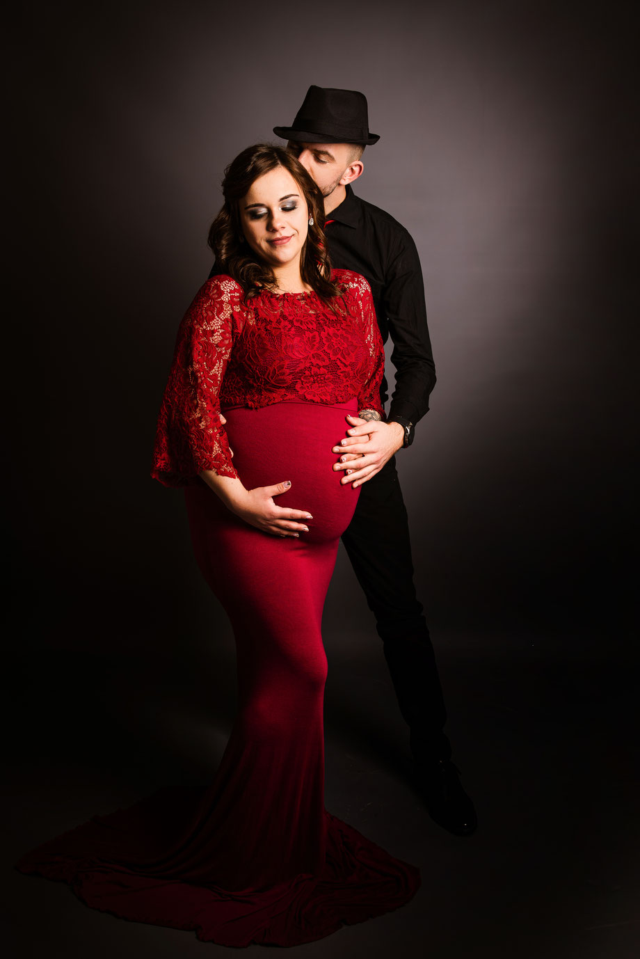 couple maternity shoot with red dress