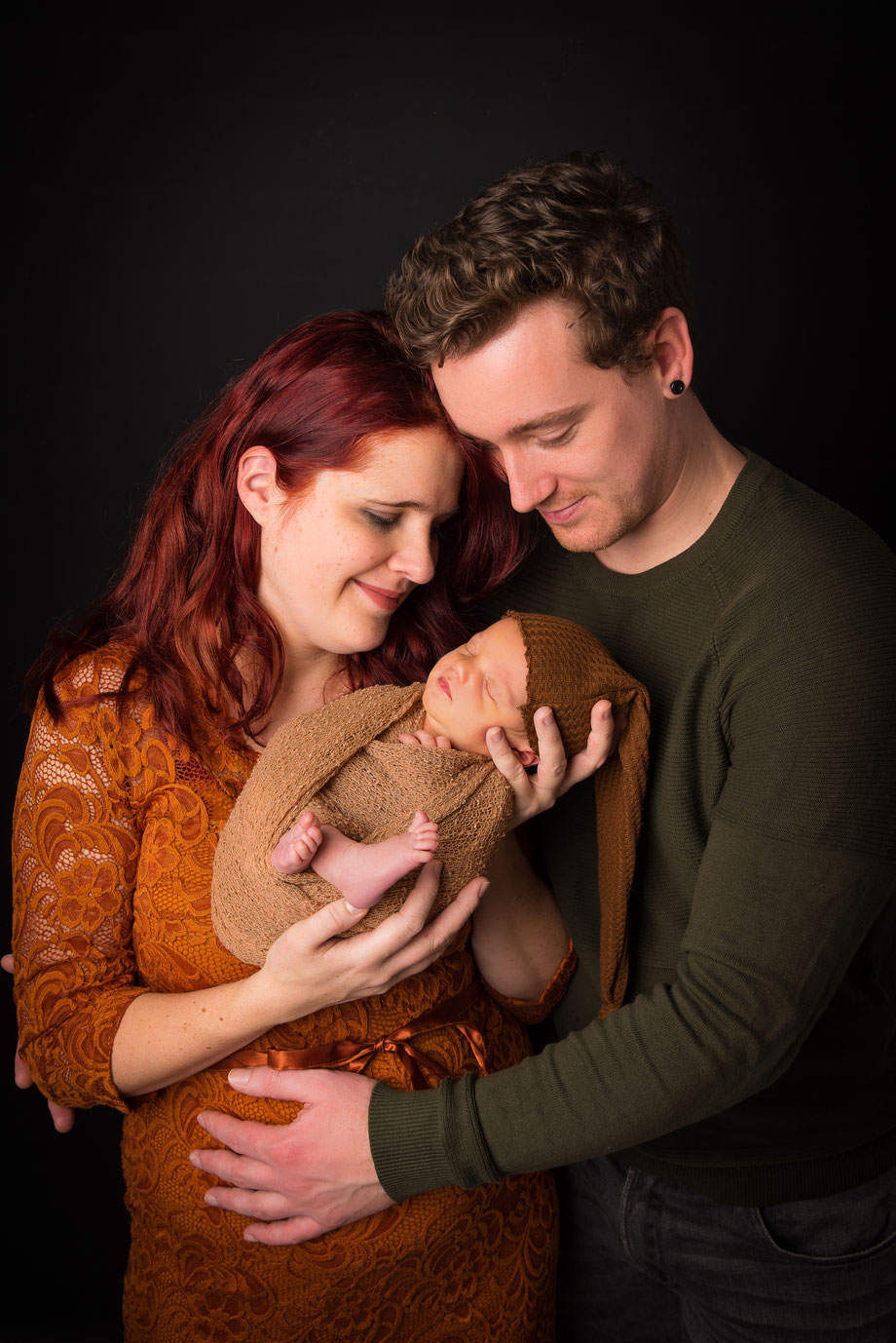 newborn with parents dark scenery