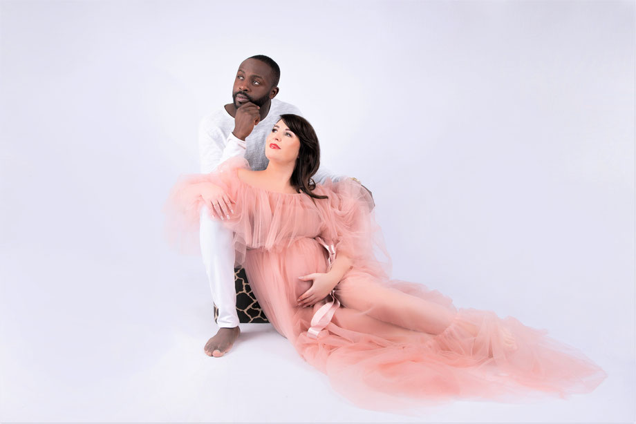 pregnant woman in pink dress and husband