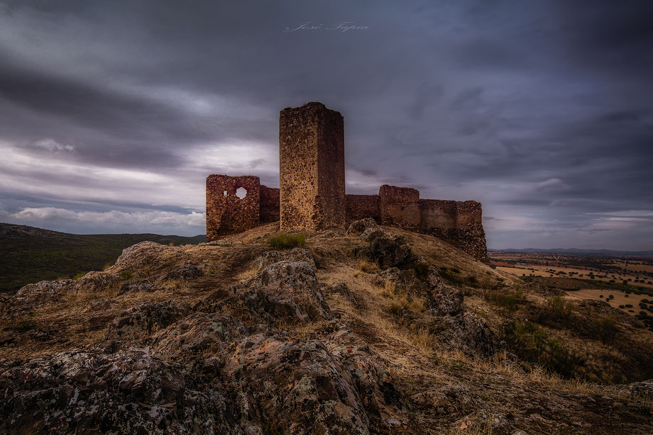 "STONE OF YEARS". A ruins of an old castle in Castilla la Mancha a cloudy day, Spain.