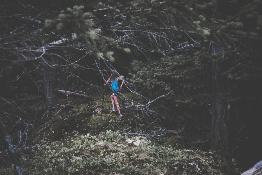 Woman running through forest Minimalist Biohacker approach to strength and stamina