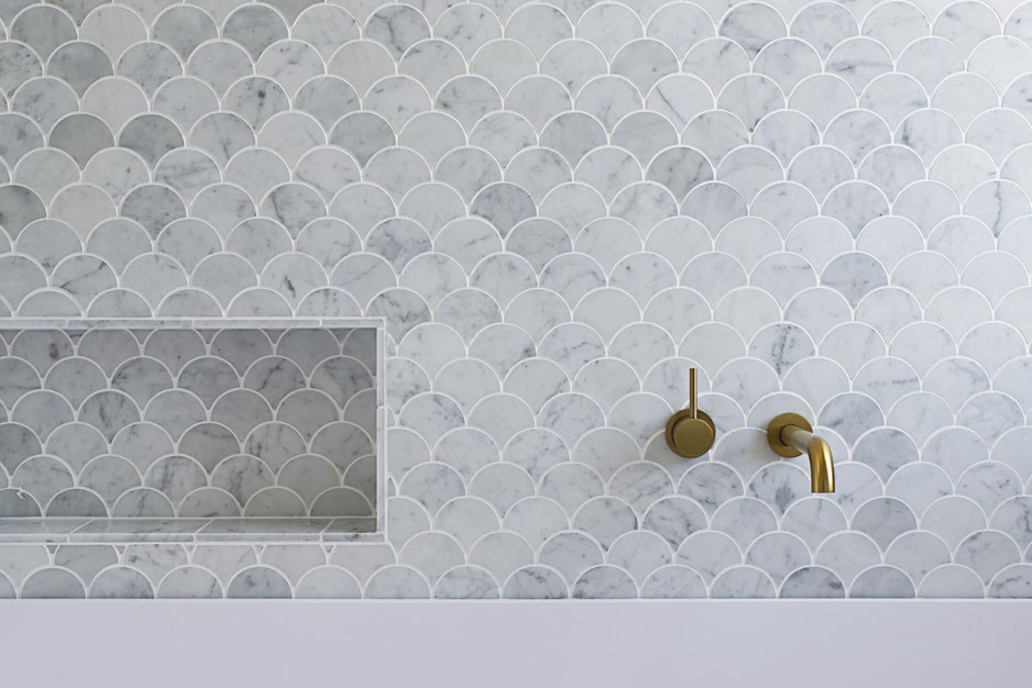 Marble fish-scale tile feature wall in coastal Ocean View bathroom Flourish