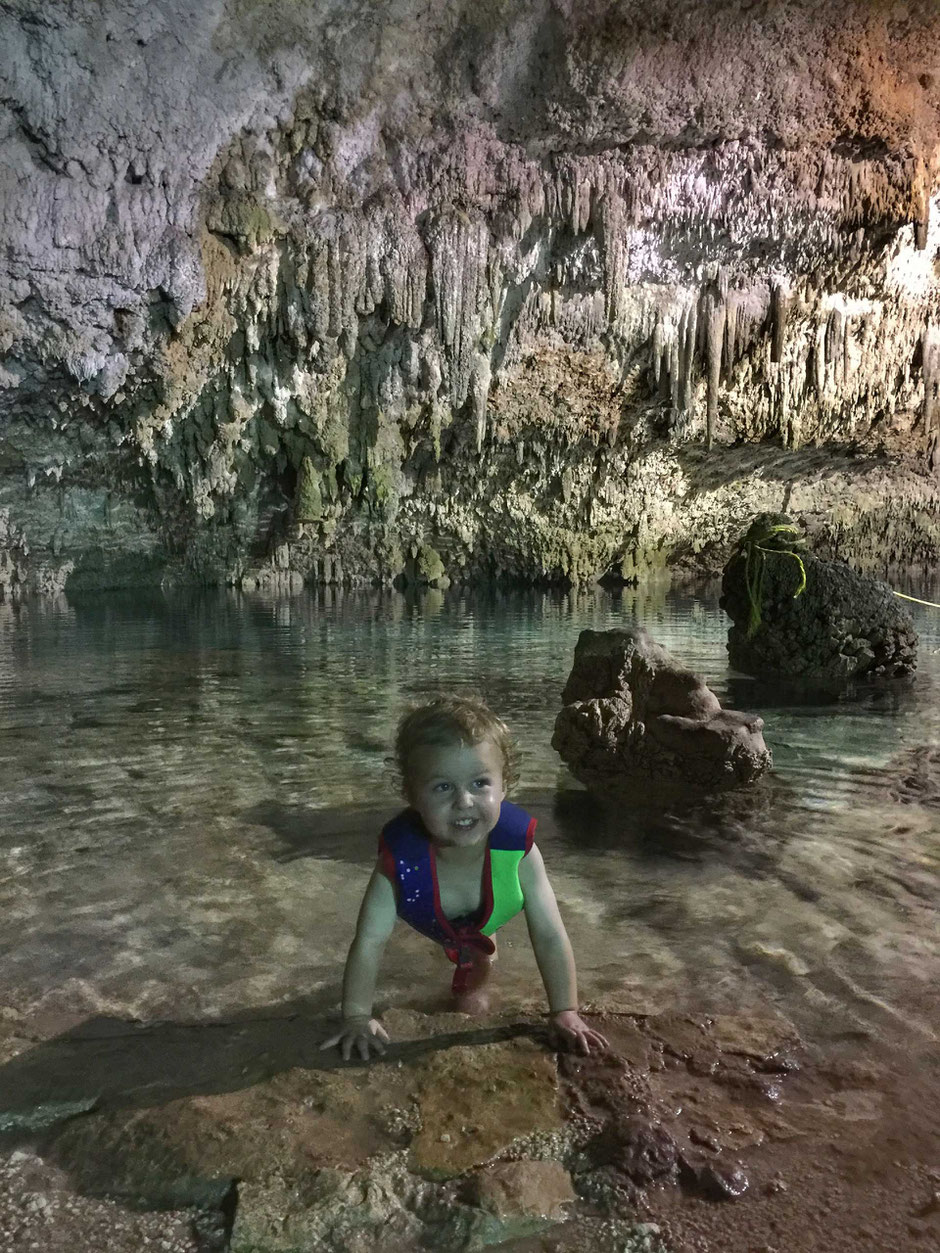 Toddler swimming in Cenote Choo-ha near Coba in Mexico