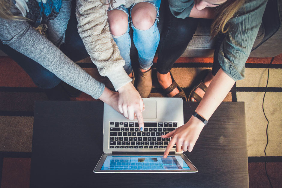 Young people looking at online content on a laptop