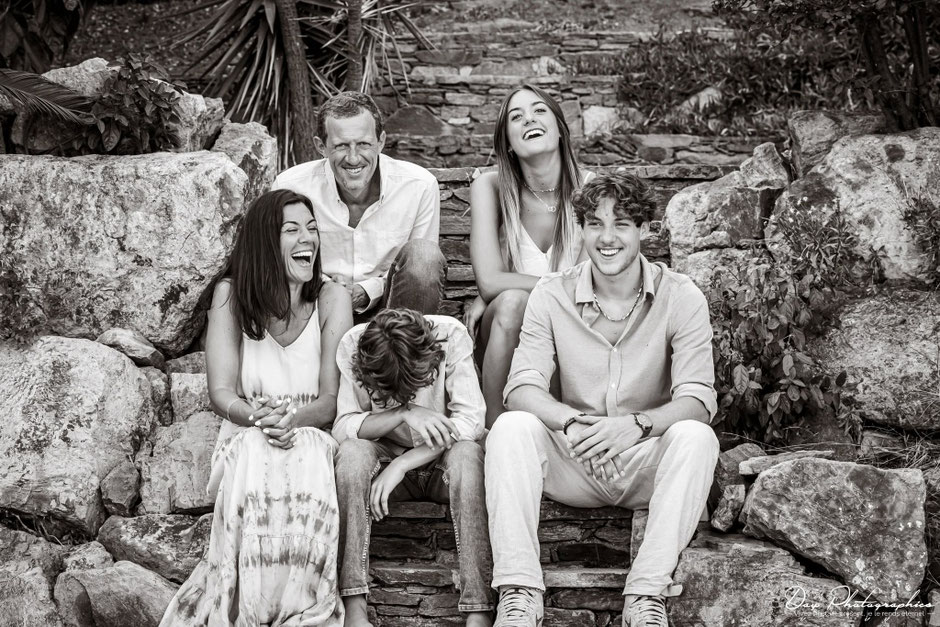 Three-generation family laughing together during a photoshoot in Saint-Tropez.