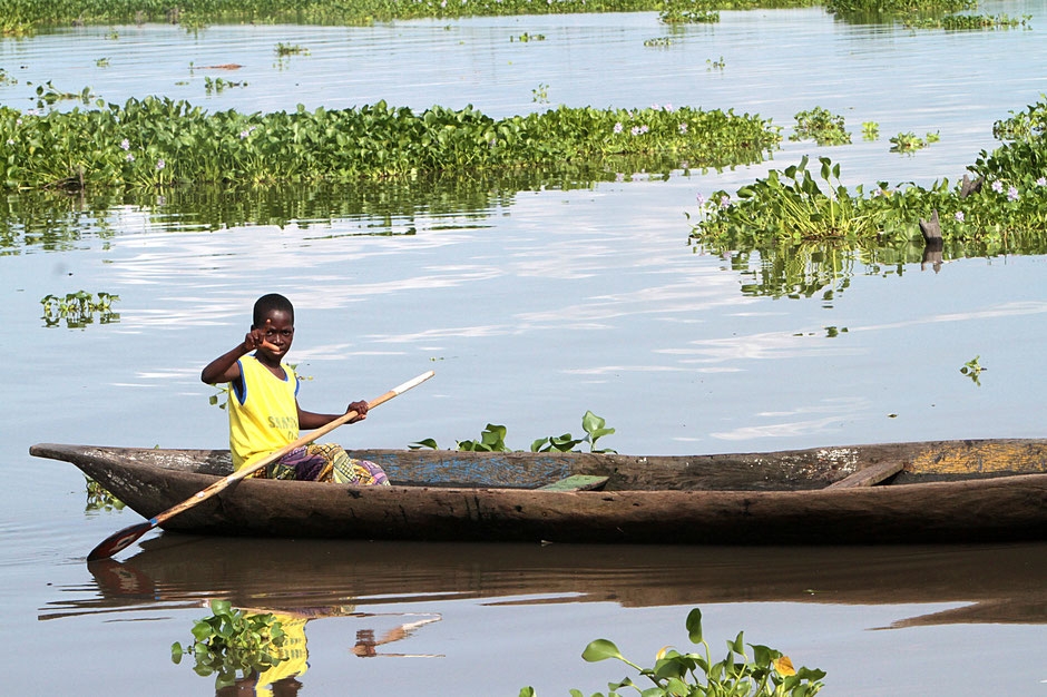 African children in a canoe. Lakeside town. Lake Nokoue. Ganvie.