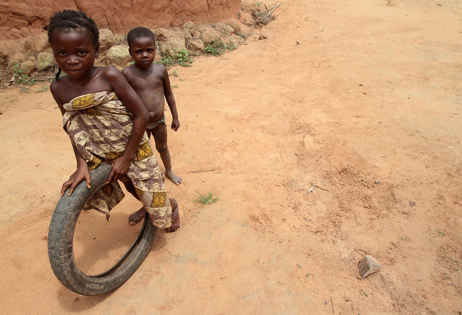 Beninese girl fun to roll an old tire. Tori.