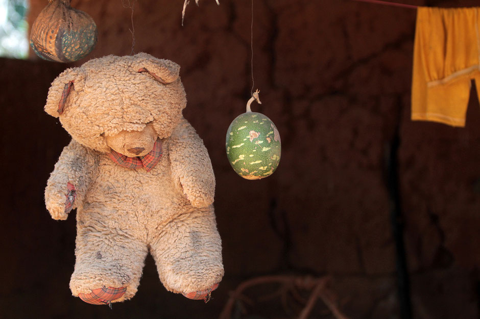 Teddy bear hanging from a window. Tori.