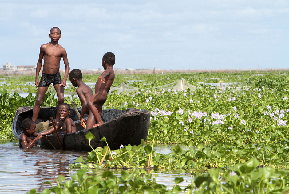 African children playing on a canoe. Lake Nokoue. Ganvie.