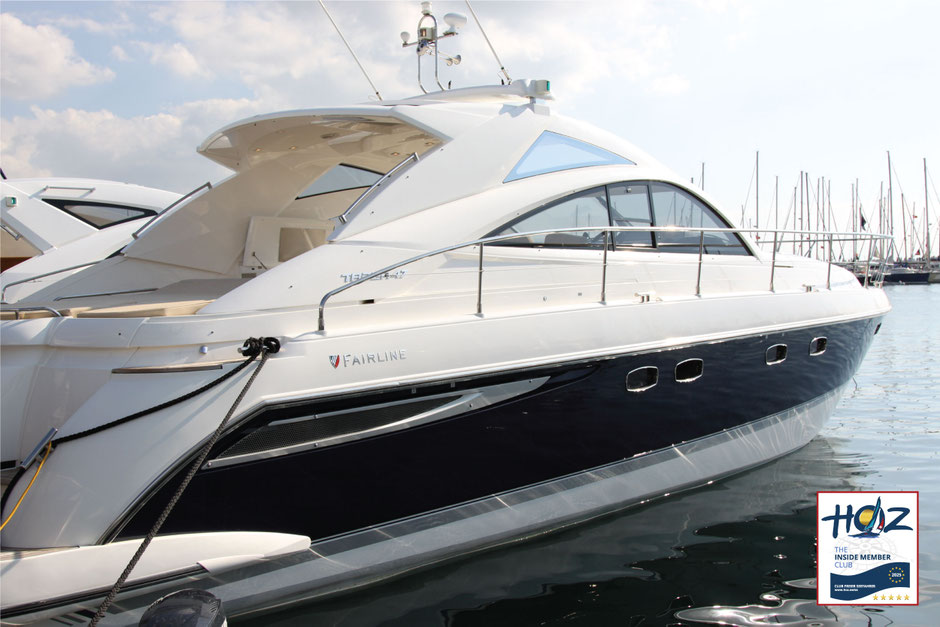 Weisses Motorboot im Sonnenlicht auf ruhiger See, Darstellung von Komfort und maritimer Technik.