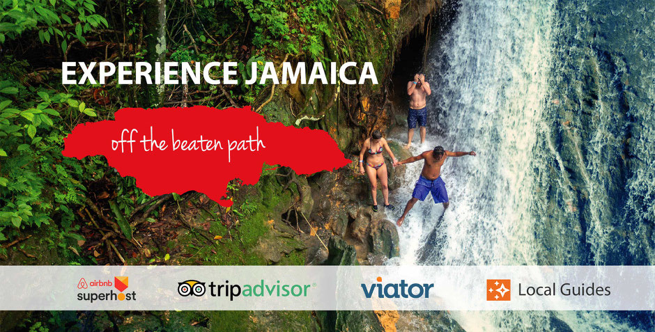 Tour guide and a couple of tourists at Island Gully Falls attraction standing near the waterfall at the excursion in Jamaica