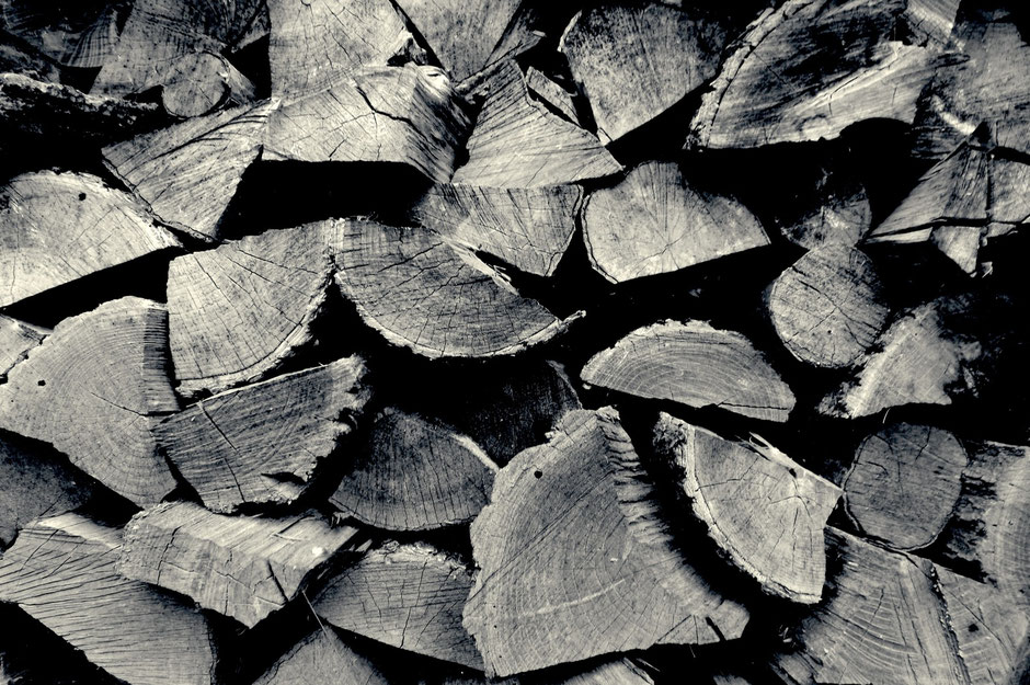 Stacked logs, black and white