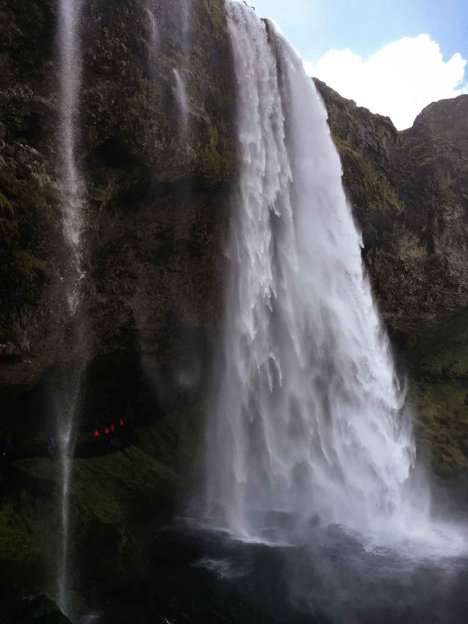 Walking behind Seljalandsfoss in South Iceland