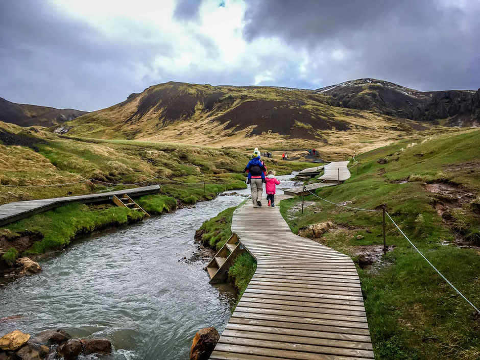 Walking the boardwalks along the Hveragerði Hot Springs River Trail in Iceland with kids