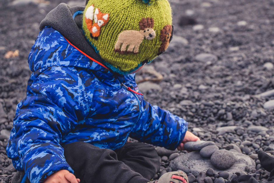 Playing with rocks on Djupalonssandur Beach Snaefellsjoekull National Park Iceland with kids