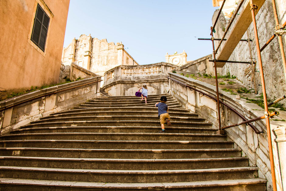 Climbing the stairs to St. Ignatius Church in Dubrovnik Croatia with children