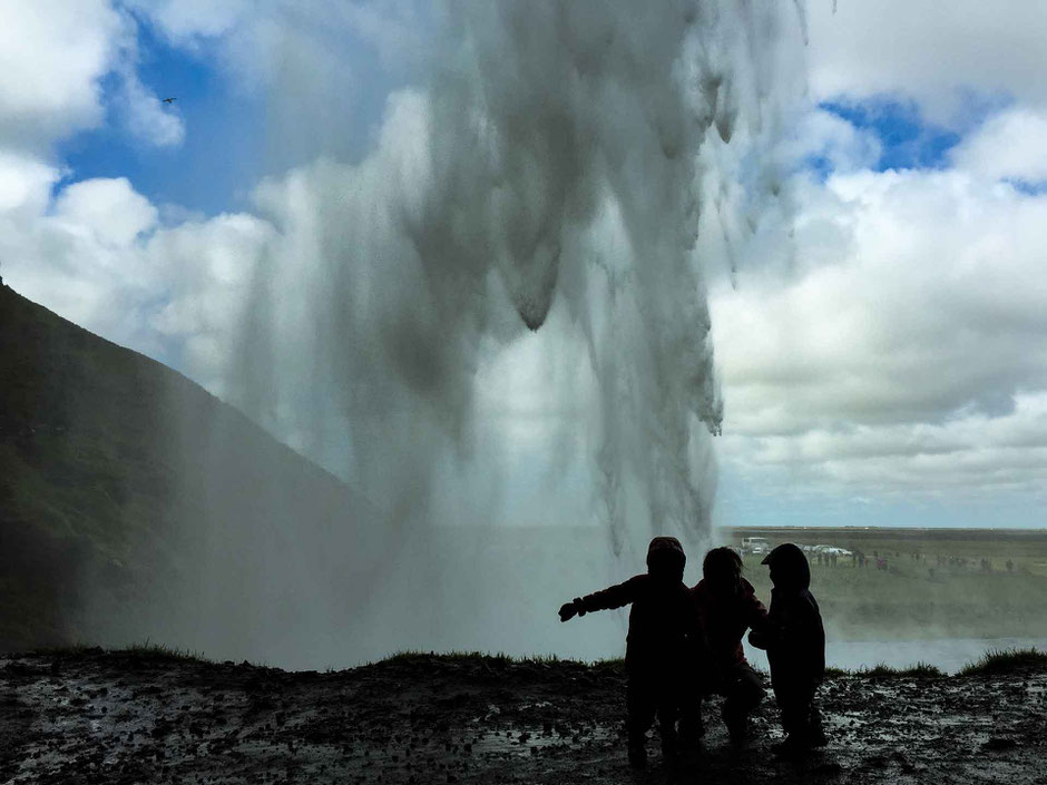 Walking behind Seljalandsfoss in South Iceland with small kids